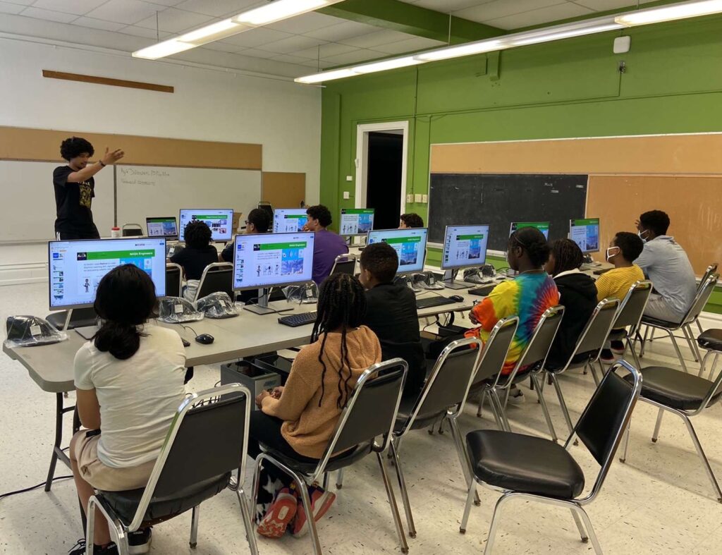 AVELA team presenting in a classroom.