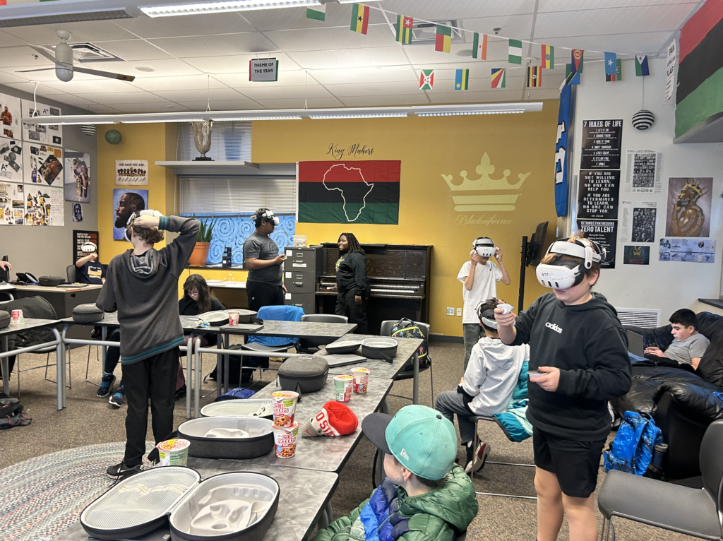 Children trying virtual reality headsets in a classroom.